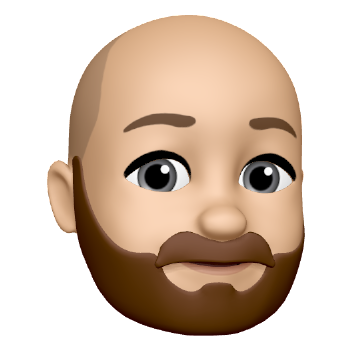 Memoji of Mike Greco. He is a bald white male with a beard.